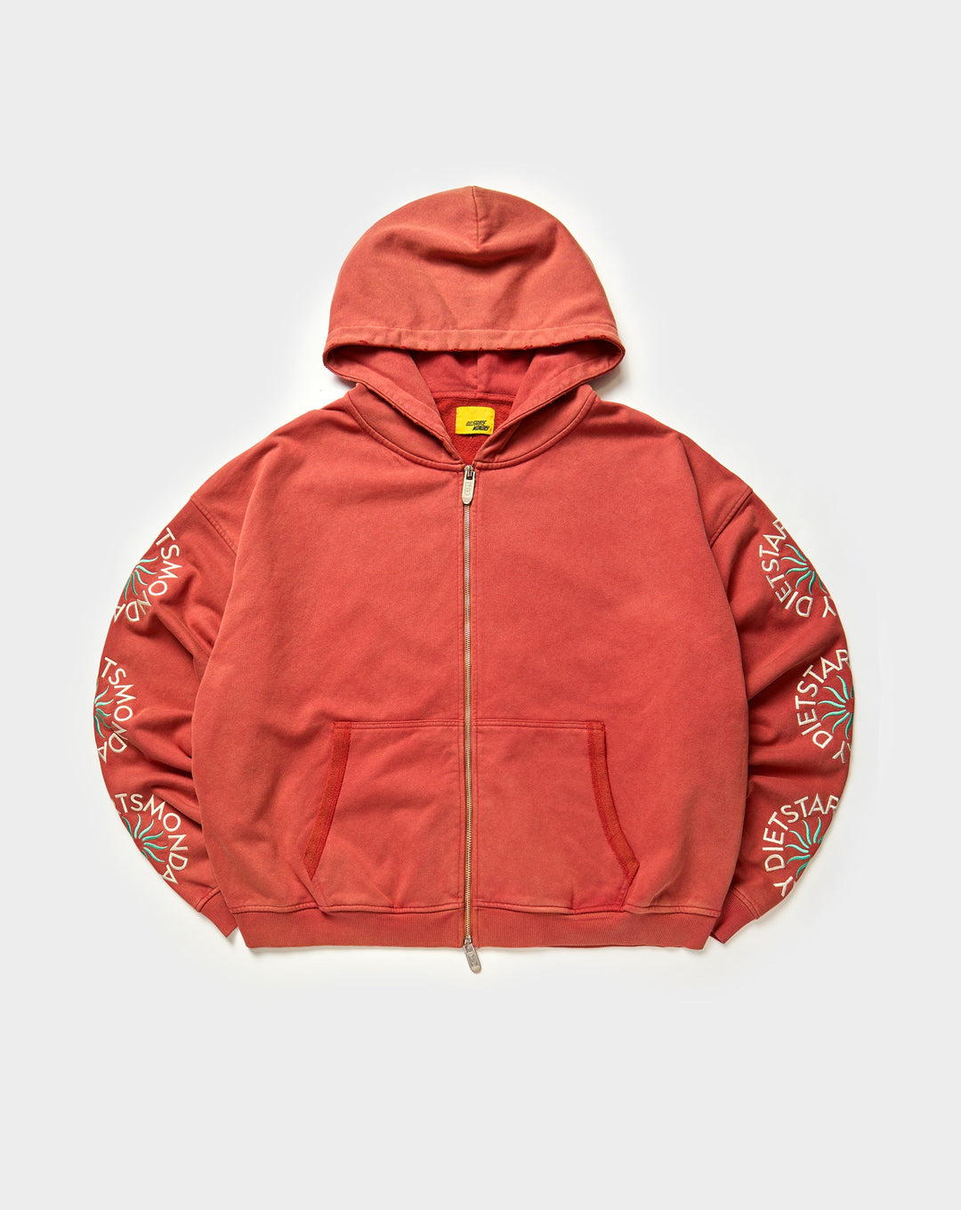 Red hoodie with branding on sleeves against a white background